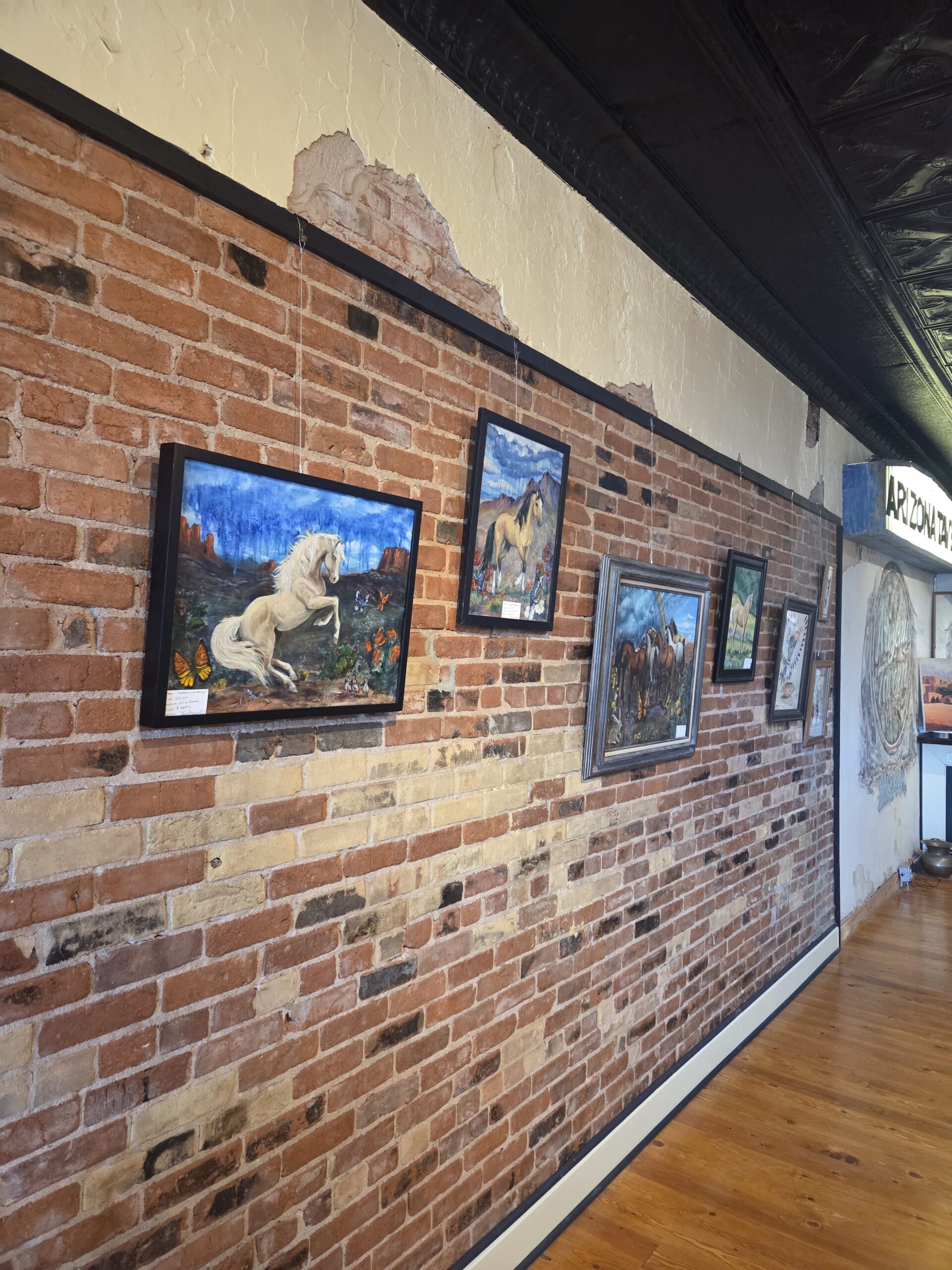 Paintings hanging on the gallery wall