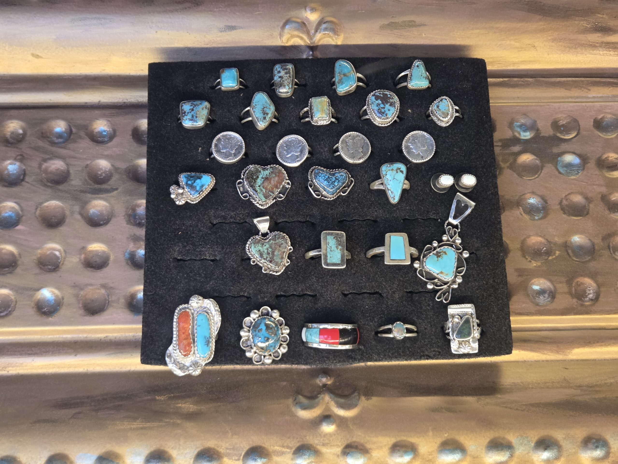 Turquoise and silver jewelry arranged in a display case