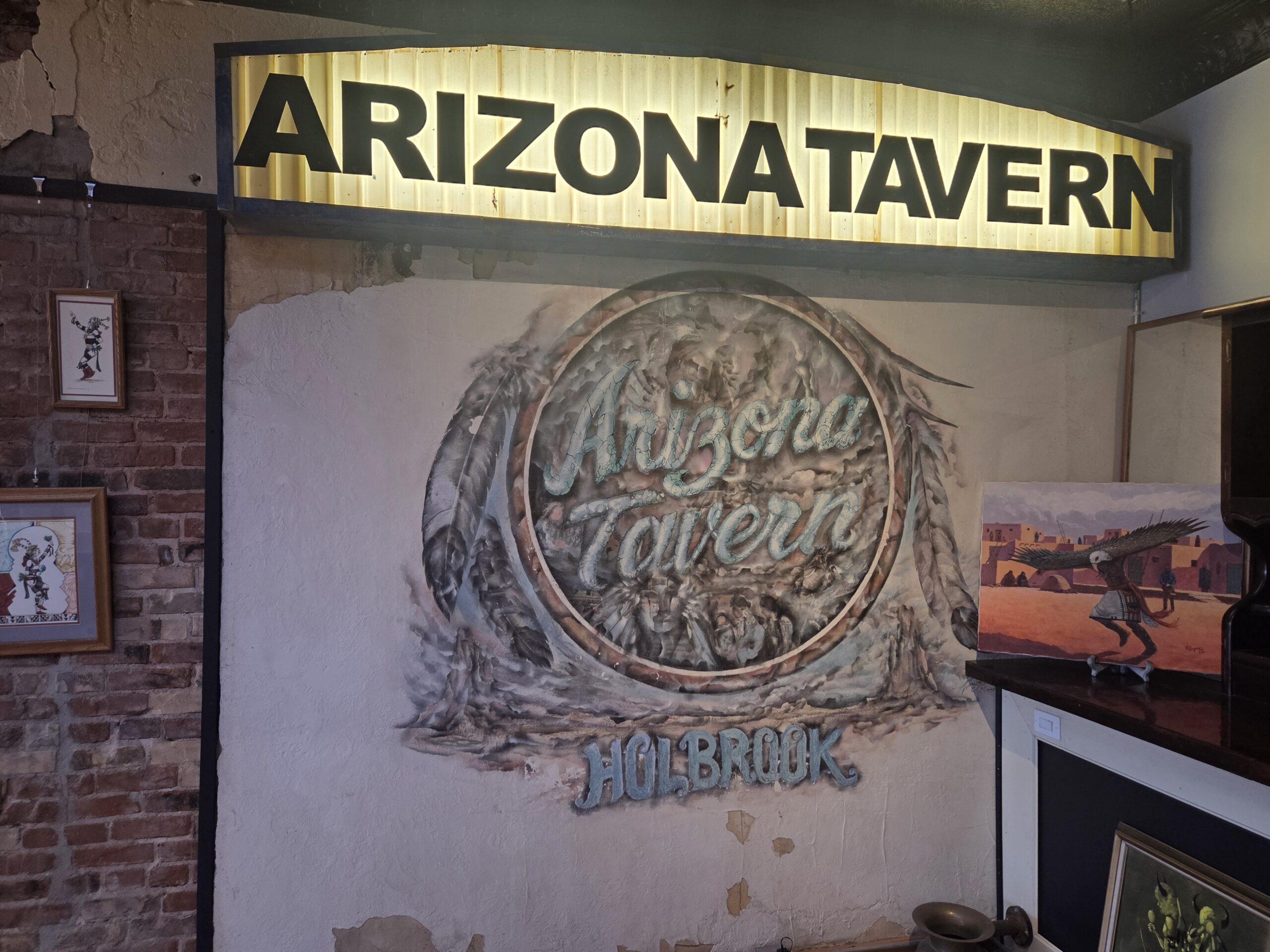 The hand painted Arizona Tavern mural on a brick wall inside The Gandy Dancer Gallery