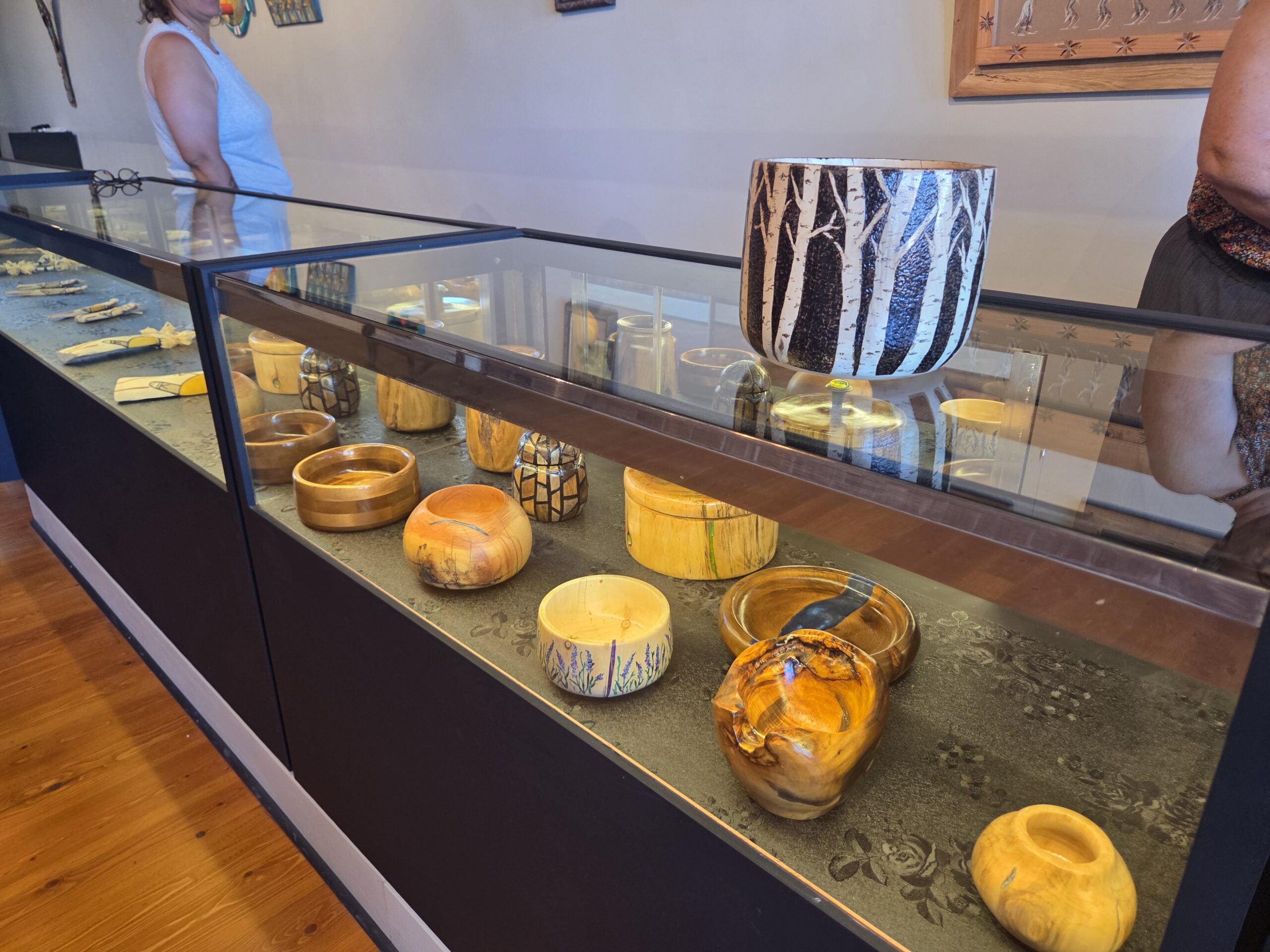 Handmade pottery and vessels in a lit display case
