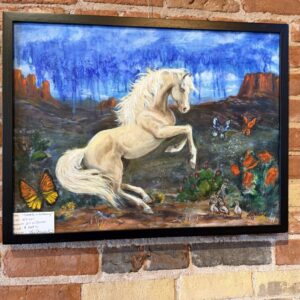 Cremello in the Morning, an oil painting by Liz Nichols of a cream colored horse rearing in a red rock desert with monarch butterflies and poppies